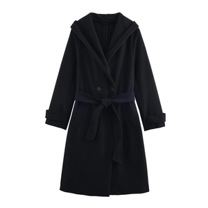 Detail of black hooded coat with double-breasted buttons and adjustable sleeve cuffs
