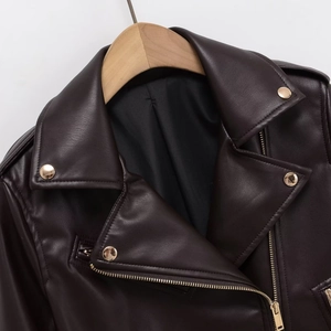 Women's burgundy PU leather biker jacket with lapels and gold hardware on hanger