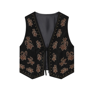 Close-up of black suede vest with brown floral embroidery and tie-up front detail