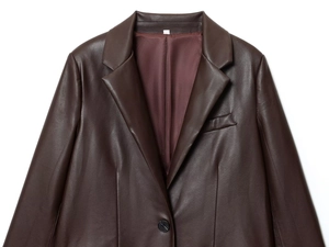 Détail du blazer en similicuir marron foncé avec revers à cran et doublure en satin