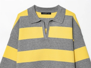Detail of yellow and grey striped knit sweater featuring a polo collar and soft texture