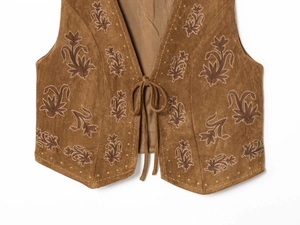 Close-up of vintage brown suede vest featuring floral embroidery and lace-up front detail