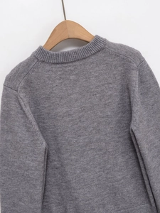 Detail of grey knitted cardigan with ribbed crew neck and high-quality fabric texture
