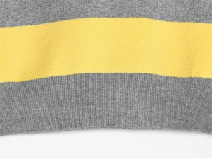 Close-up of grey and yellow horizontal wide striped knit fabric texture and soft wool fibers
