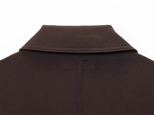 Detailed view of the dark brown jacket collar and high-quality reinforced stitching