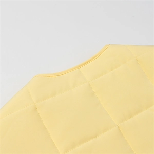 Yellow quilted round neck cotton jacket with long sleeves in a relaxed casual style