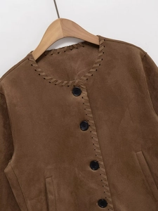 Close-up of brown suede jacket showing whipstitch collar details and button closure