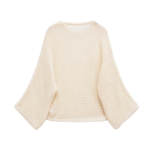 Close-up of off-white hollow knit sweater featuring oversized batwing sleeves detail