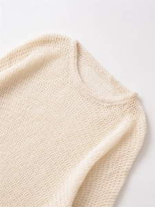 Close-up of beige knit sweater showing delicate mesh texture and soft mohair fibers