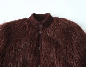 Detail of burgundy faux fur cardigan featuring ribbed knit collar and button closure