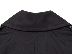 Detail of premium black trench coat featuring precise stitching and high-quality collar texture