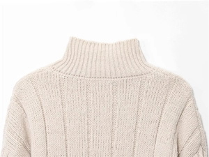 Detailed view of the ribbed round neckline on this beige chunky knit sweater for women