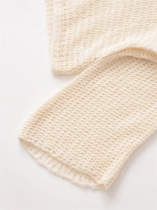 Detail of cream openwork knit texture on casual crewneck sweater with wool finish