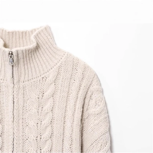 Women's cream white cable knit sweater with a high collar and front zipper detail