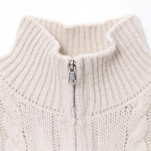 Chic beige cable knit sweater featuring a stylish high neck and silver metal zipper detail