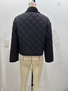 Detailed back view of black quilted jacket featuring classic diamond stitch patterns