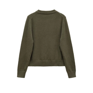 Detail of the dark green knit sweater back showing ribbed cuffs and textured hemline