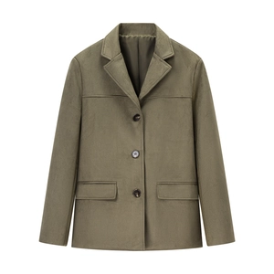 Close-up of olive suede blazer featuring single-breasted buttons and flap pocket detail