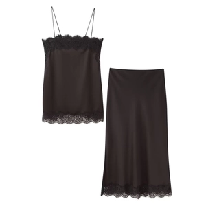 Detail of black satin camisole and midi skirt set with delicate eyelash lace trim