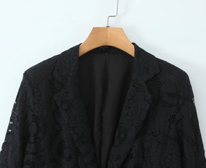 Detail of delicate black lace fabric texture and floral patterns on women blazer