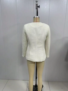 Rear view of white tweed jacket showing elegant texture and slim fit on mannequin