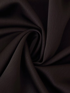 Close-up of premium dark satin fabric showing soft texture and elegant draped folds