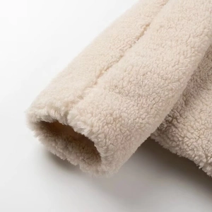 Close-up of plush off-white Sherpa fleece texture and high-quality cuff stitching