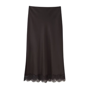 Detailed close-up of a black satin midi skirt featuring elegant floral lace trim at the hem