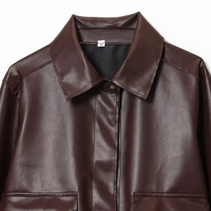 Flat lay of a dark brown faux leather cropped jacket for women with symmetrical pockets