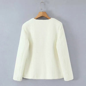 Detail view of the cream tweed jacket back with textured weave on a wooden hanger