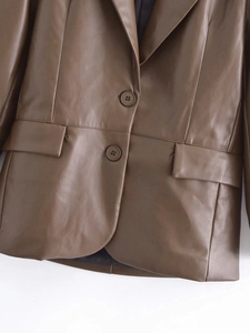 Close-up of brown faux leather blazer with notched lapels and two-button closure detail