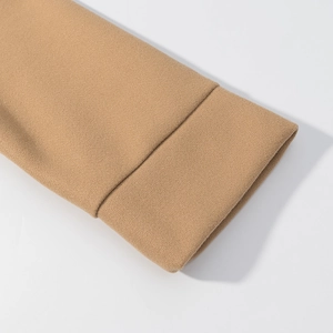 Detail showing high-quality camel wool fabric and neat double-stitched seams on the cuff