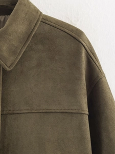 Detail of olive green suede jacket showing high-quality shoulder seams and soft texture
