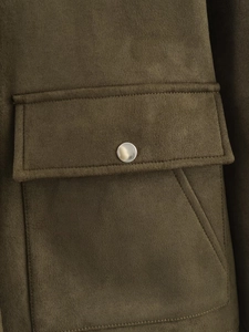 Macro shot of olive green suede jacket featuring pocket flap with silver metal snap button