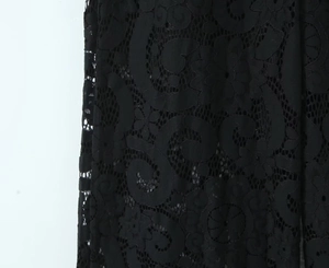 Macro detail of intricate black hollow lace fabric with elegant floral pattern texture