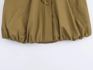 Detail of bomber jacket featuring adjustable drawstring waist with gold metal toggles