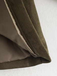 Detail of army green faux suede jacket showing neat stitching and satin lining texture