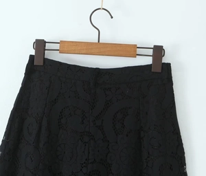 Detail of high-waist black floral lace pants with delicate openwork and inner lining