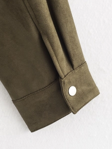 Detailed close-up of army green faux suede jacket sleeve with silver snap button
