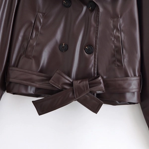 Short brown PU leather double-breasted trench coat with waist tie and marble-textured buttons