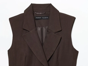 Close-up of dark brown vest collar showing fine woven texture and sizing label detail