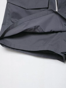 Detail of grey cargo skort showing precision double-layer hem stitching and durable fabric