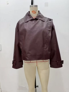 Detail of burgundy PU leather jacket featuring lapel collar and asymmetric button closure