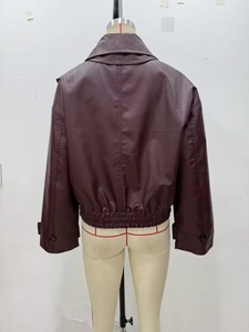 Detail view of burgundy faux leather jacket back with elastic hem and drop shoulder