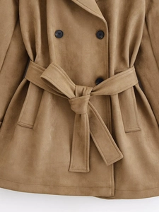 Detail of camel faux suede trench coat with double-breasted buttons and tied waist belt