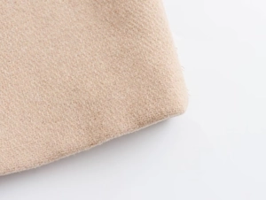 Macro shot of light camel wool fabric with premium twill texture and seam finish