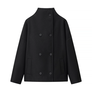 Detail of a black double-breasted coat with stand collar and high-quality wool finish