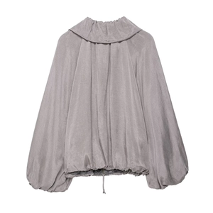 Detail of ruffled stand collar and lantern sleeves on a grey oversized women's jacket