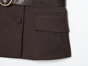 Detail of coffee brown blazer with twill texture and crocodile embossed belt with gold buckle