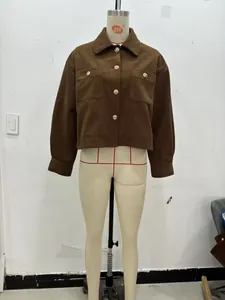 Macro detail of brown corduroy jacket showing lapel collar and golden metal buttons